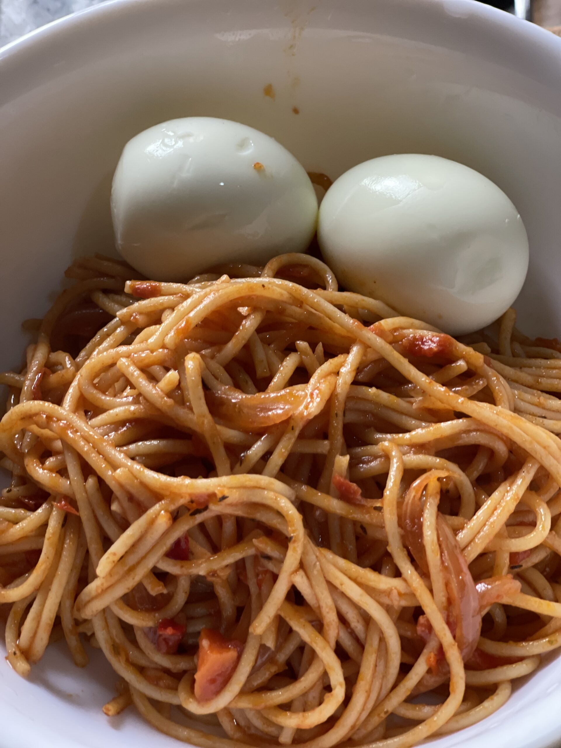 Jollof Spaghetti with boiled eggs